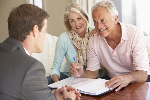 couple looking over estate planning paperwork with their attorney